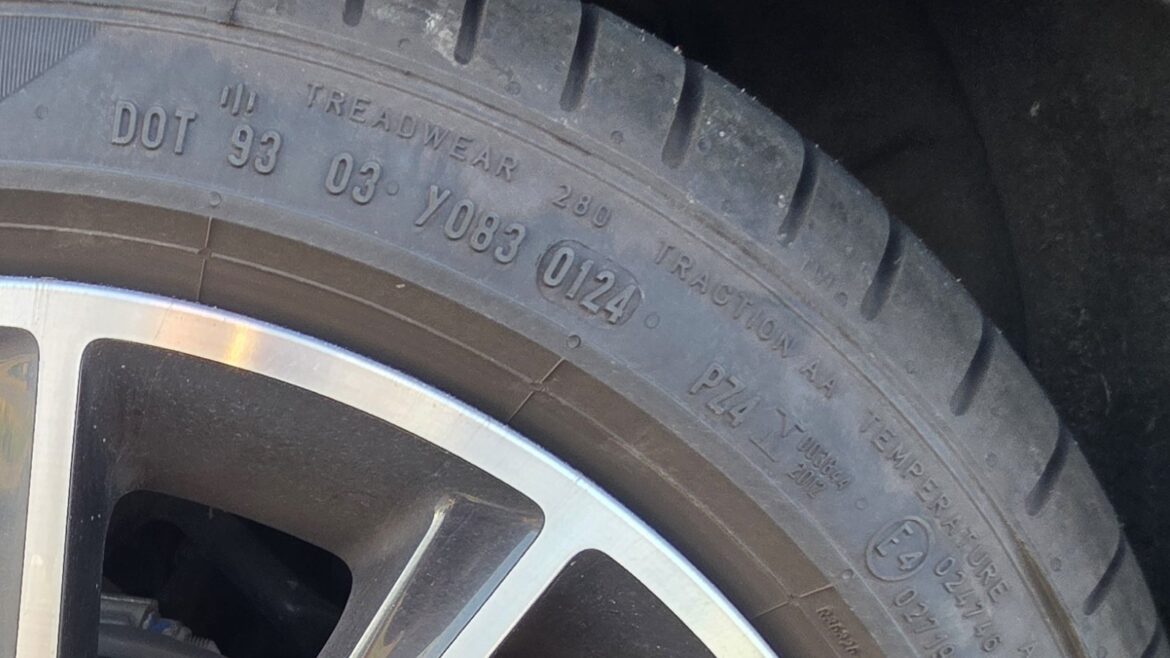 Detail boku pneumatiky osobního auta s čitelným kódem DOT 93 03 Y083 0124 a údaji Treadwear 280 a Traction AA