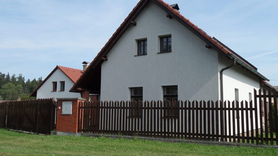 Rodinný dům s dřevěným plotem na vesnici